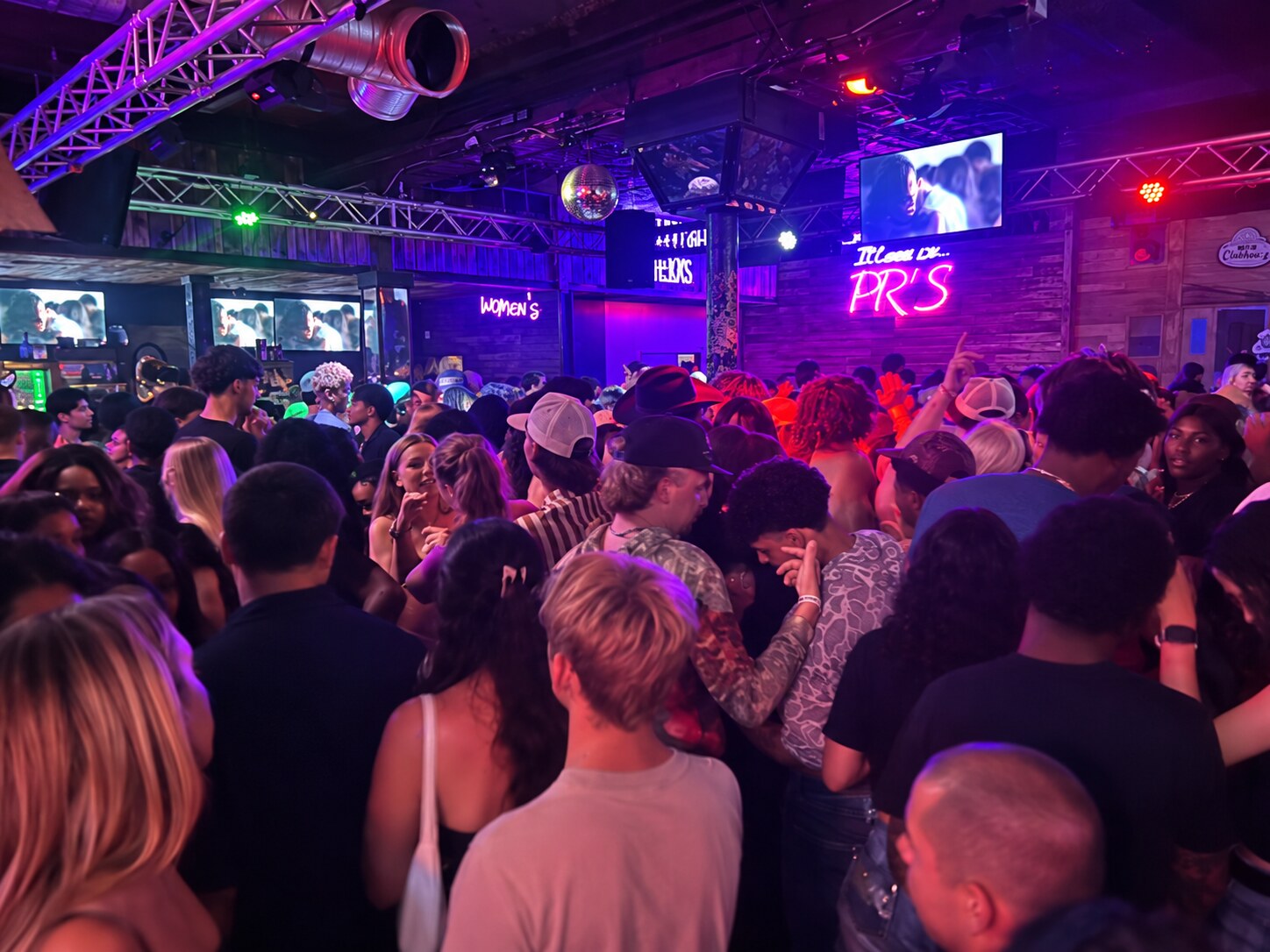 A busy night at PR’s Saloon, with the pink PR’s neon glowing above the crowd